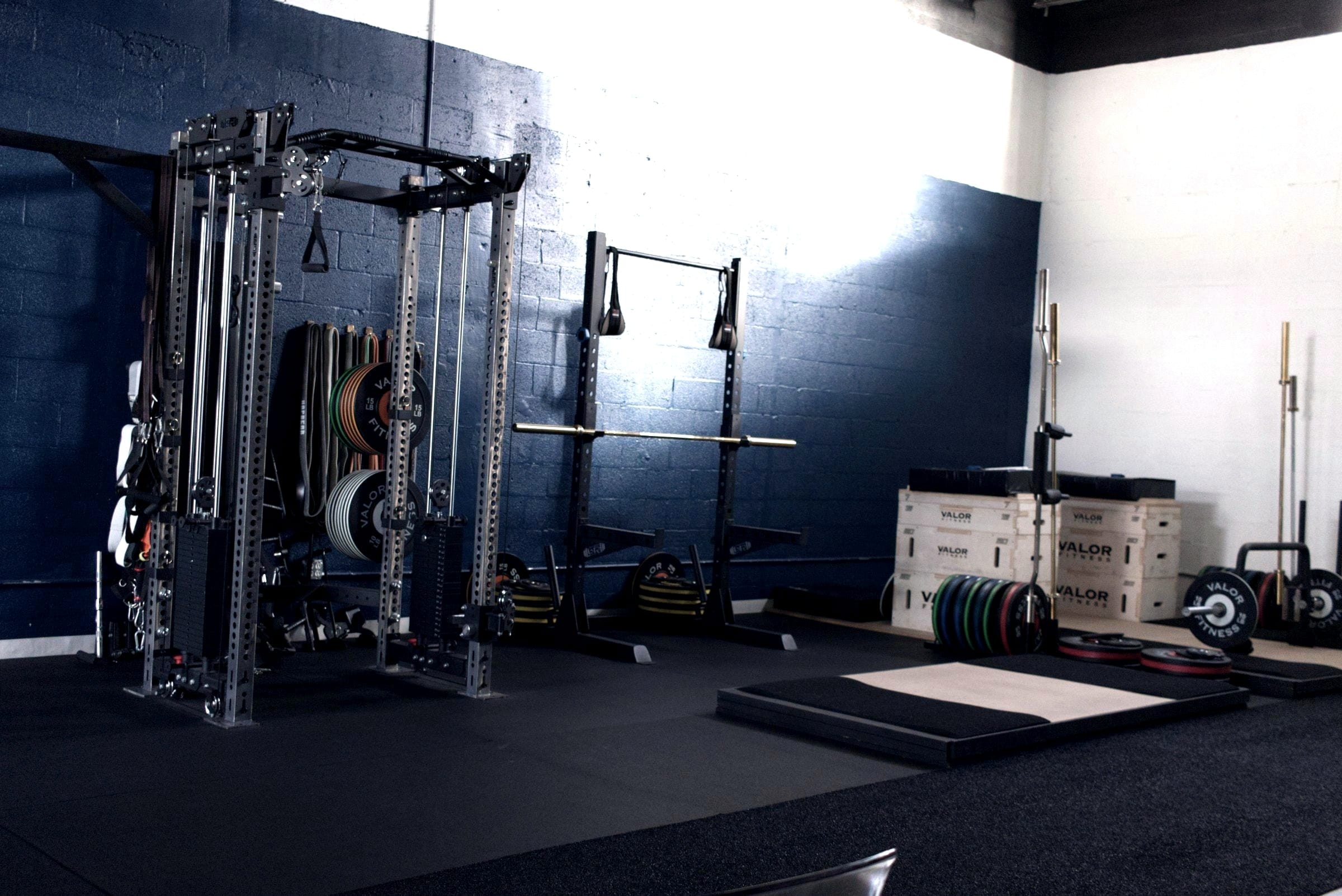 A training space being set up: racks, a platform and unopened equipment boxes.